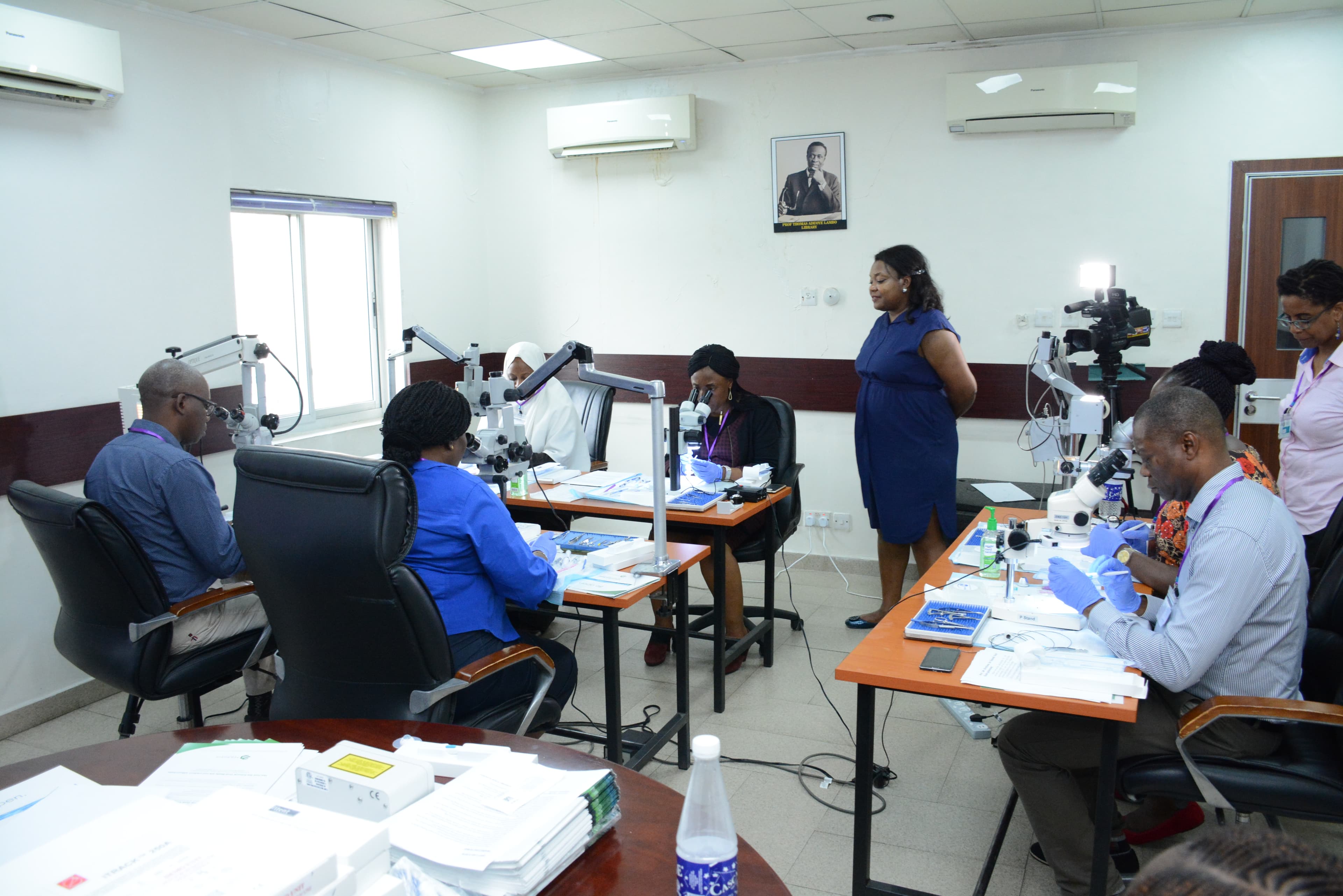 A group of doctors participate in a wet lab exercise