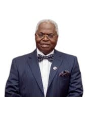 professional portrait of Dr Adekunle Olubola Hassan, founder of Eye Foundation Hospital and chairman of KHEFA, dressed in a navy blue suit and matching bow tie.